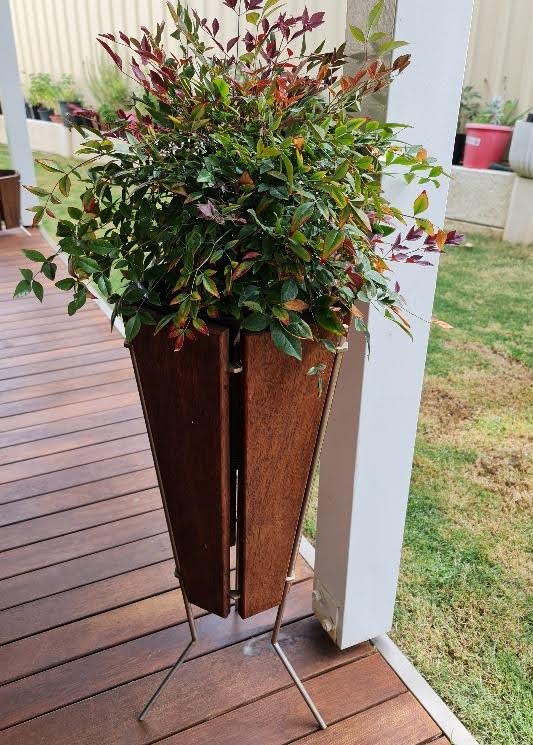 planter outdoors with a small plan inside